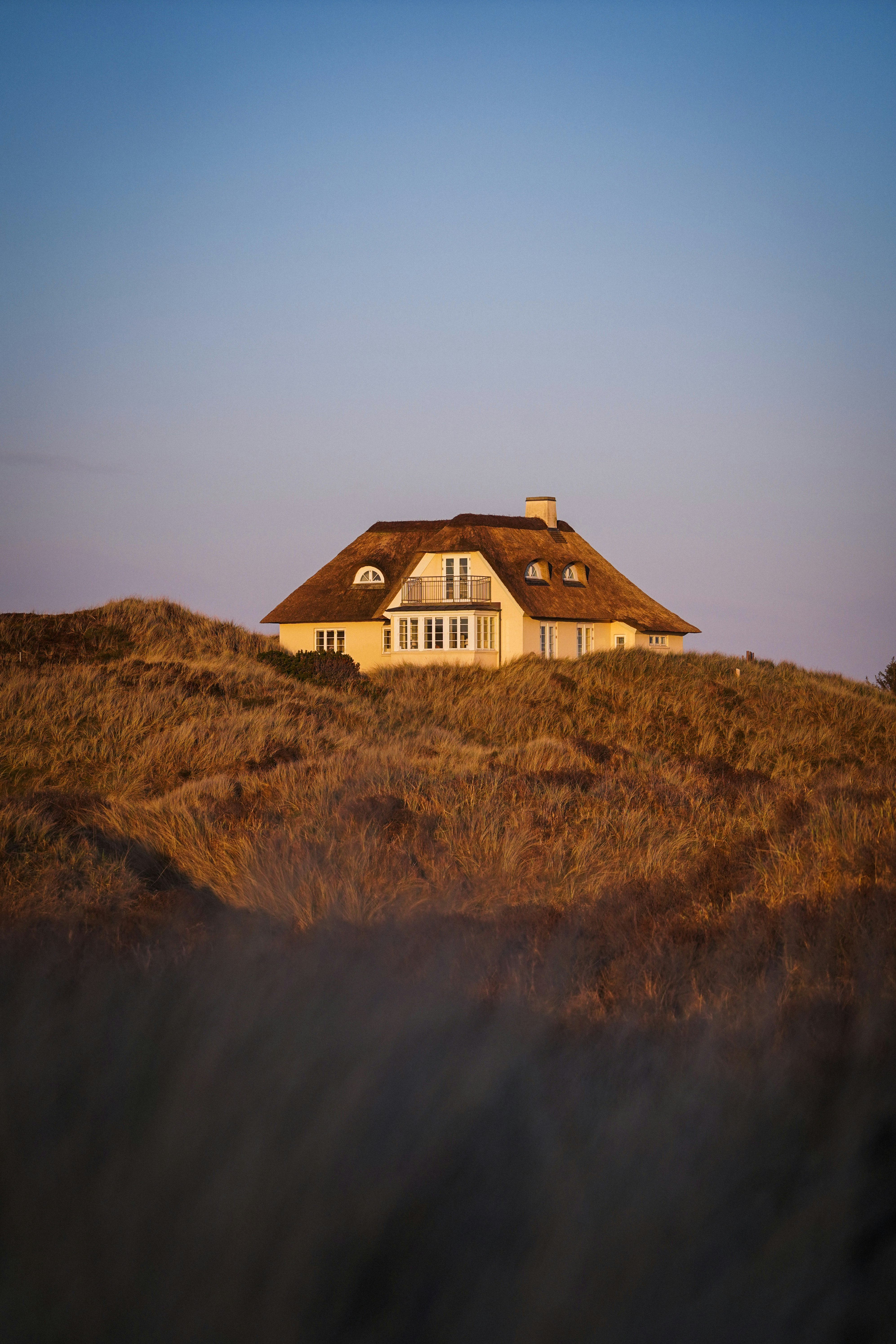 white and brown house on brown grass field